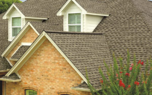 Brick home with brown roof shingles