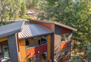 Metal roofing on multi-story home in the woods 